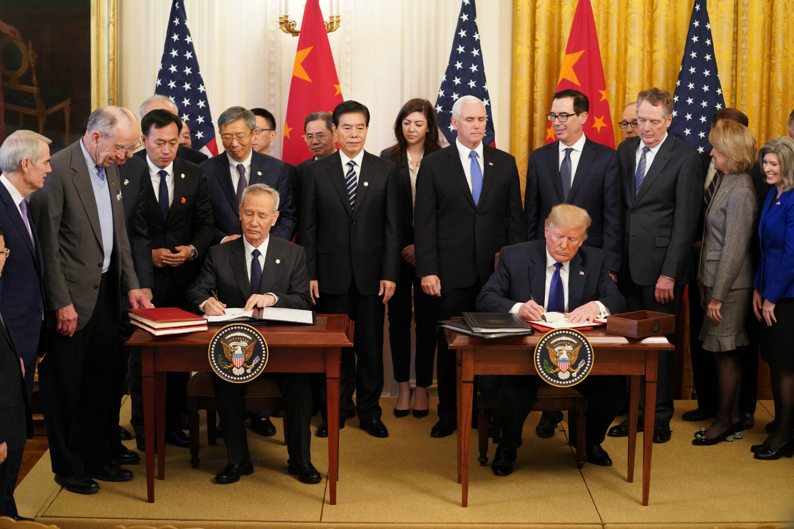 U.S. President Donald Trump and Chinese Vice Premier Liu He, who is also a member of the Political Bureau of the Communist Party of China Central Committee and chief of the Chinese side of the China-U.S. comprehensive economic dialogue, sign the China-U.S. phase-one economic and trade agreement during a ceremony at the East Room of the White House in Washington D.C., the United States, Jan. 15, 2020. (Xinhua/Wang Ying)