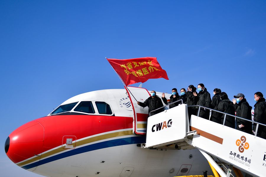 Members of a medical team heading for Wuhan of Hubei Province board the plane in Xining, northwest China