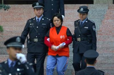 Xie&nbsp;Caiping&nbsp;is&nbsp;escorted&nbsp;to&nbsp;leave&nbsp;the&nbsp;court&nbsp;after&nbsp;the&nbsp;sentences&nbsp;in&nbsp;southwest&nbsp;China's&nbsp;Chongqing&nbsp;Municipality,&nbsp;Nov.&nbsp;3,&nbsp;2009.&nbsp;Organized&nbsp;crime&nbsp;boss&nbsp;Xie&nbsp;Caiping,&nbsp;labeled&nbsp;the&nbsp;"godmother&nbsp;of&nbsp;the&nbsp;underworld"&nbsp;in&nbsp;Chongqing,&nbsp;was&nbsp;sentenced&nbsp;to&nbsp;18&nbsp;years&nbsp;in&nbsp;prison&nbsp;Tuesday.&nbsp;The&nbsp;other&nbsp;21&nbsp;accomplices,&nbsp;including&nbsp;officials&nbsp;who&nbsp;offered&nbsp;protection&nbsp;to&nbsp;gang&nbsp;members,&nbsp;were&nbsp;given&nbsp;jail&nbsp;terms&nbsp;ranging&nbsp;from&nbsp;one&nbsp;to&nbsp;13&nbsp;years&nbsp;in&nbsp;sentences&nbsp;by&nbsp;the&nbsp;Chongqing&nbsp;No.&nbsp;5&nbsp;Intermediate&nbsp;People's&nbsp;Court.(Xinhua/Chen&nbsp;Cheng)