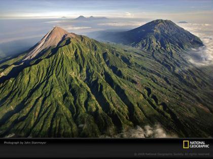 Green&nbsp;vegetation&nbsp;surrounds&nbsp;villages&nbsp;on&nbsp;the&nbsp;slopes&nbsp;of&nbsp;Mount&nbsp;Merapi,&nbsp;a&nbsp;highly&nbsp;active&nbsp;volcano&nbsp;in&nbsp;Central&nbsp;Java,&nbsp;Indonesia.&nbsp;Thousands&nbsp;of&nbsp;people,&nbsp;lured&nbsp;by&nbsp;fertile&nbsp;volcanic&nbsp;soils,&nbsp;live&nbsp;on&nbsp;or&nbsp;near&nbsp;Merapi.&nbsp;Many&nbsp;lives&nbsp;have&nbsp;been&nbsp;lost&nbsp;to&nbsp;the&nbsp;volcano�s&nbsp;frequent&nbsp;eruptions,&nbsp;which&nbsp;are&nbsp;accompanied&nbsp;by&nbsp;high-speed&nbsp;pyroclastic&nbsp;flows&nbsp;and&nbsp;mudflows&nbsp;called&nbsp;lahars.