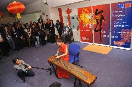 An actress performs Chinese guqin, a seven-stringed plucked musical instrument in some ways similar to the zither, during a cultural presentation of the Chinese lunar new year at the European Parliament headquarters in Brussels, capital of Belgium, Feb. 2, 2010. (Xinhua/Wu Wei)