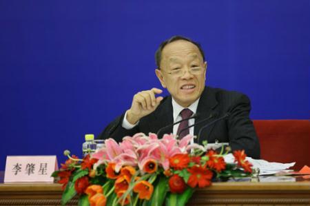 Li Zhaoxing, spokesman for the Third Session of the 11th National People's Congress (NPC), answers questions from journalists during the news conference on the Third Session of the 11th NPC at the Great Hall of the People in Beijing, capital of China, March 4, 2010.(Xinhua/Xing Guangli)