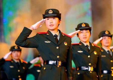 Paramilitary policewomen salute and vow to serve the upcoming 2010 World Expo during an oath campaign in Shanghai March 8, 2010. Nearly 4,000 women from all walks of life took part in the activity to mark the International Women's Day which falls on March 8 annually. [Photo/Xinhua]