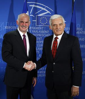 Greece's Prime Minister George Papandreou (L) is welcomed by European Parliament President Jerzy Buzek (R) ahead of a meeting in Brussels March 18, 2010.  (Xinhua/Reuters Photo)