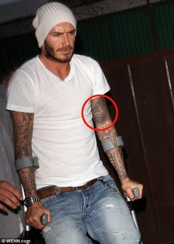 In memory: David Beckham in Los Angeles yesterday on crutches sporting a new tattoo in tribute to his late grandfather Joseph West