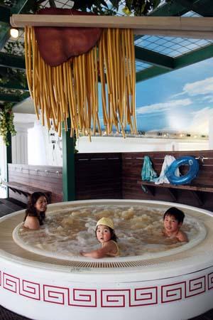 Visitors enjoy the "soup noodle spa" at the Hakone Yunessun Spa on April 19, 2008 in Hakone, Kanagawa Prefecture, Japan. The spa, which has previously offered customers spa baths filled with chocolate and Beaujolais wine, is celebrating their 10 millionth visitor since their opening in 2001 with the Soup Noodle Spa until June 30. (April 19, 2008 - Photo by Junko Kimura/Getty Images AsiaPac) 