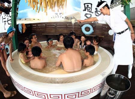 Ichiro Furuya, founder and cook of a popular noodle store "Nantsuttei" throws the imitation noodles bath agent into "soup noodle spa" at the Hakone Yunessun Spa on April 19, 2008 in Hakone, Kanagawa Prefecture, Japan. The spa, which has previously offered customers spa baths filled with chocolate and Beaujolais wine, is celebrating their 10 millionth visitor since their opening in 2001 with the Soup Noodle Spa until June 30. (April 19, 2008 - Photo by Junko Kimura/Getty Images AsiaPac) 