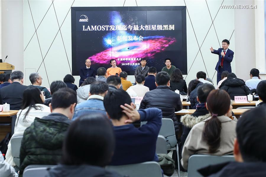 Liu Jifeng (1st R Back), deputy director-general of the National Astronomical Observatory of the Chinese Academy of Sciences (NAOC) and the first author of the study, speaks during a press conference of the black hole LB-1 discovered with the Large Sky Area Multi-Object Fibre Spectroscopy Telescope (LAMOST), in Beijing, capital of China, Nov. 27, 2019. A Chinese-led research team has discovered a surprisingly huge stellar black hole about 14,000 light years from Earth -- our "backyard" of the universe -- forcing scientists to re-examine how such black holes form. The team, headed by Liu Jifeng, spotted the black hole, which has a mass 70 times greater than the Sun. Researchers named the monster black hole LB-1. (Xinhua)
