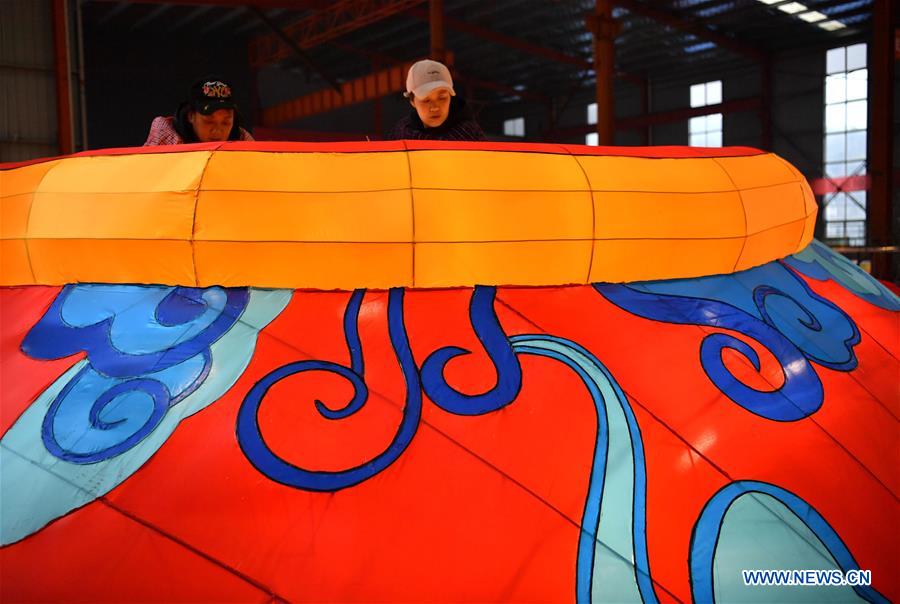 Workers make a large colored lantern at a factory in Xuan