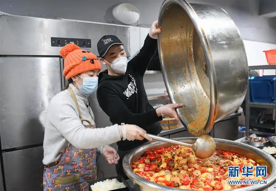 2月26日，“雨衣妹妹”（左）和伙计在准备菜肴。新华社记者　程敏　摄