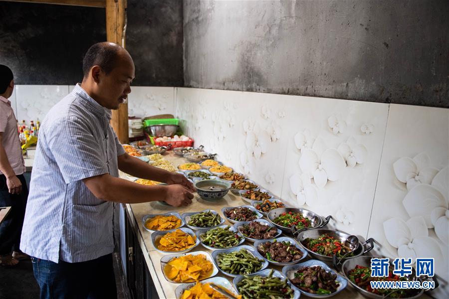 在湘西十八洞村，杨正邦在自家开的饭店厨房里帮忙（6月30日摄）。 新华社记者 陈思汗 摄