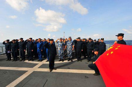 Chinese navy soldiers swear to celebrate the first anniversary of the Chinese fleet's escort mission on Ma'anshan frigate of the fourth Chinese naval flotilla in the Gulf of Aden, Dec. 26, 2009.(Xinhua/Yang Zhigang)
