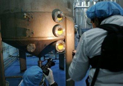 Photographers take pictures of machines using processed uranium at the Isfahan nuclear facility in southern Iran. Iran says it is considering plans to start building two new uranium enrichment plants from March, with the sites concealed in the mountains to avert air strikes. (AFP/File/Behrouz Mehri)