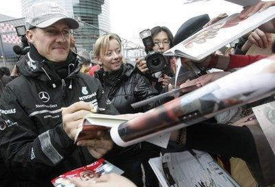 Mercedes Formula One driver Michael Schumacher of Germany signs autographs for fans at the Chinese Formula One Grand Prix in Shanghai, China, Thursday.
