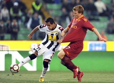 Udinese's Alexis Alejandro Sanchez, of Chile, left, chased by AS Roma's John Arne Riise, of Norway, scores during the Italian Cup semifinal second leg soccer match between Udinese and AS Roma in Udine, Italy, Wednesday, April 21, 2010. AS Roma lined up an Italian Cup final against Inter Milan despite a 1-0 loss to Udinese.(AP Photo/Franco Debernardi)