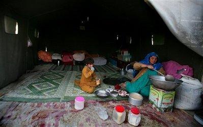 An&nbsp;internally&nbsp;displaced&nbsp;Afghan&nbsp;woman&nbsp;cooks&nbsp;food&nbsp;as&nbsp;her&nbsp;daughter&nbsp;sits&nbsp;next&nbsp;to&nbsp;her&nbsp;inside&nbsp;their&nbsp;tent&nbsp;at&nbsp;a&nbsp;refugee&nbsp;camp&nbsp;in&nbsp;Kabul,&nbsp;Afghanistan,&nbsp;Monday,&nbsp;Oct.&nbsp;26,&nbsp;2009.&nbsp;According&nbsp;to&nbsp;UNHCR&nbsp;some&nbsp;2.7&nbsp;million&nbsp;registered&nbsp;Afghans&nbsp;refugees&nbsp;still&nbsp;remain&nbsp;in&nbsp;Pakistan&nbsp;and&nbsp;Iran.(AP&nbsp;Photo/Altaf&nbsp;Qadri)