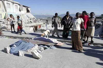 Haitians react to the destruction caused by an earthquake near the rumble of a destroyed building in Port-au-Prince. (AFP/Erika Santelices)