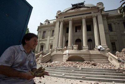 A man looks at the damages of the Accademy of Fine Arts' building in Santiago after a huge 8.8-magnitude earthquake rocked Chile. (AFP/Claudio Santana)