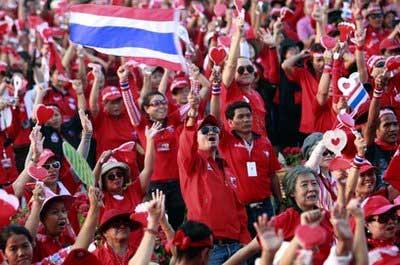 Supporters of ousted Prime Minister Thaksin Shinawatra cheer to speech from their leader on the stage during an anti-government rally in Bangkok, Thailand Saturday, March 13, 2010. (AP Photo/Apichart Weerawong)