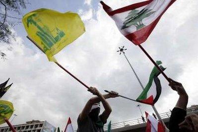 Lebanon's Hezbollah supporters wave flags during an anti-Israel protest organized by Palestinian and Lebanese parties in Beirut March 19, 2010. The protest was held against Israel's settlement building plans in Jerusalem.REUTERS/Jamal Saidi 