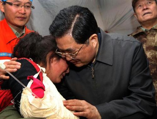 Chinese President Hu Jintao (R front) gives a hug to injured student Zhoema of Tibetan ethnic group during his visit to those injured in the quake receiving treatment at a stadium in the Tibetan Autonomous Prefecture of Yushu, northwest China's Qinghai Province, April 18, 2010. Hu arrived in Yushu Sunday morning to direct relief work. (Xinhua/Lan Hongguang)