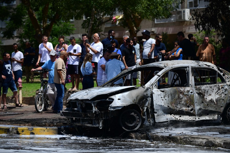 A burnt-out car hit by a rocket fired from the Gaza Strip is seen in southern Israeli city of Ashkelon, on May 11, 2021. 