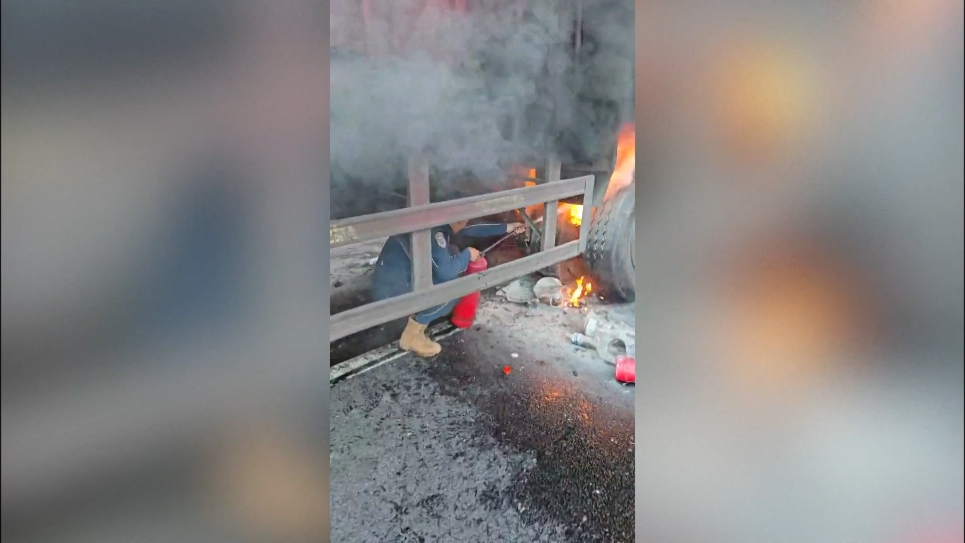 Heroic motorist bravely crawls beneath burning truck to tackle blaze on highway