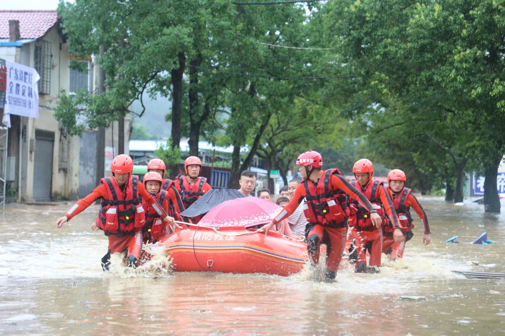 　　△2020年7月9日，在福建南平武夷山市崇安街道石雄社区，消防人员转移被洪水围困群众。