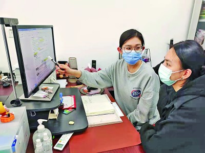 东北大学的辅导员(左)帮助大学生修改完善简历。面对疫情冲击,东北大学通过开设职涯云课、开办网上专场招聘会等帮助大学生就业。新华社发