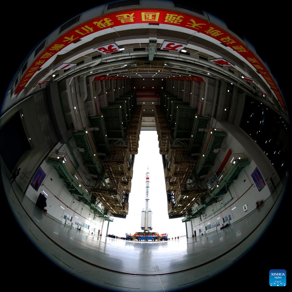 The combination of the Shenzhou-15 crewed spaceship and a Long March-2F carrier rocket is to be transferred to the launching area in Jiuquan Satellite Launch Center in northwest China, Nov. 21, 2022. (Photo by Li Yunxi/Xinhua)
