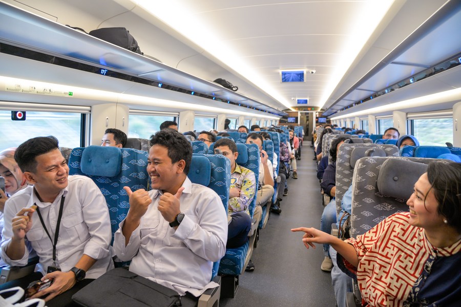 Passengers chat on a carriage of a high-speed electrical multiple unit (EMU) train running on the Jakarta-Bandung High-Speed Railway in Indonesia, Oct. 17, 2023. (Xinhua/Xu Qin)