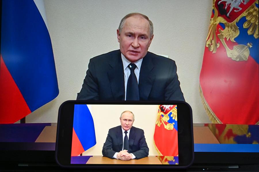 This photo taken in Moscow, Russia on March 23, 2024 shows screens displaying Russian President Vladimir Putin speaking in a televised address to the nation. (Xinhua/Cao Yang)