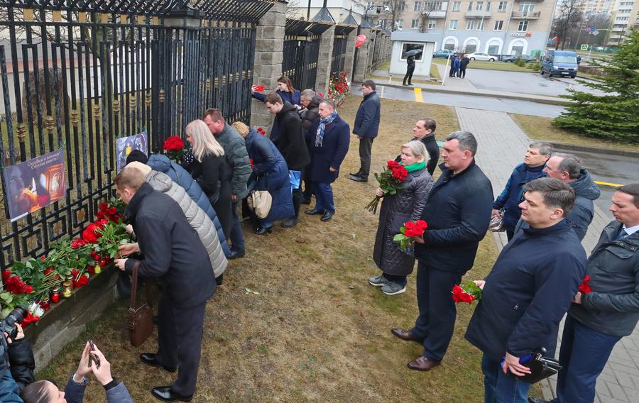 People lay flowers to commemorate victims of Moscow terrorist attack in front of the Russian Embassy in Minsk, Belarus on March 23, 2024.  (Photo by Henadz Zhinkov/Xinhua)