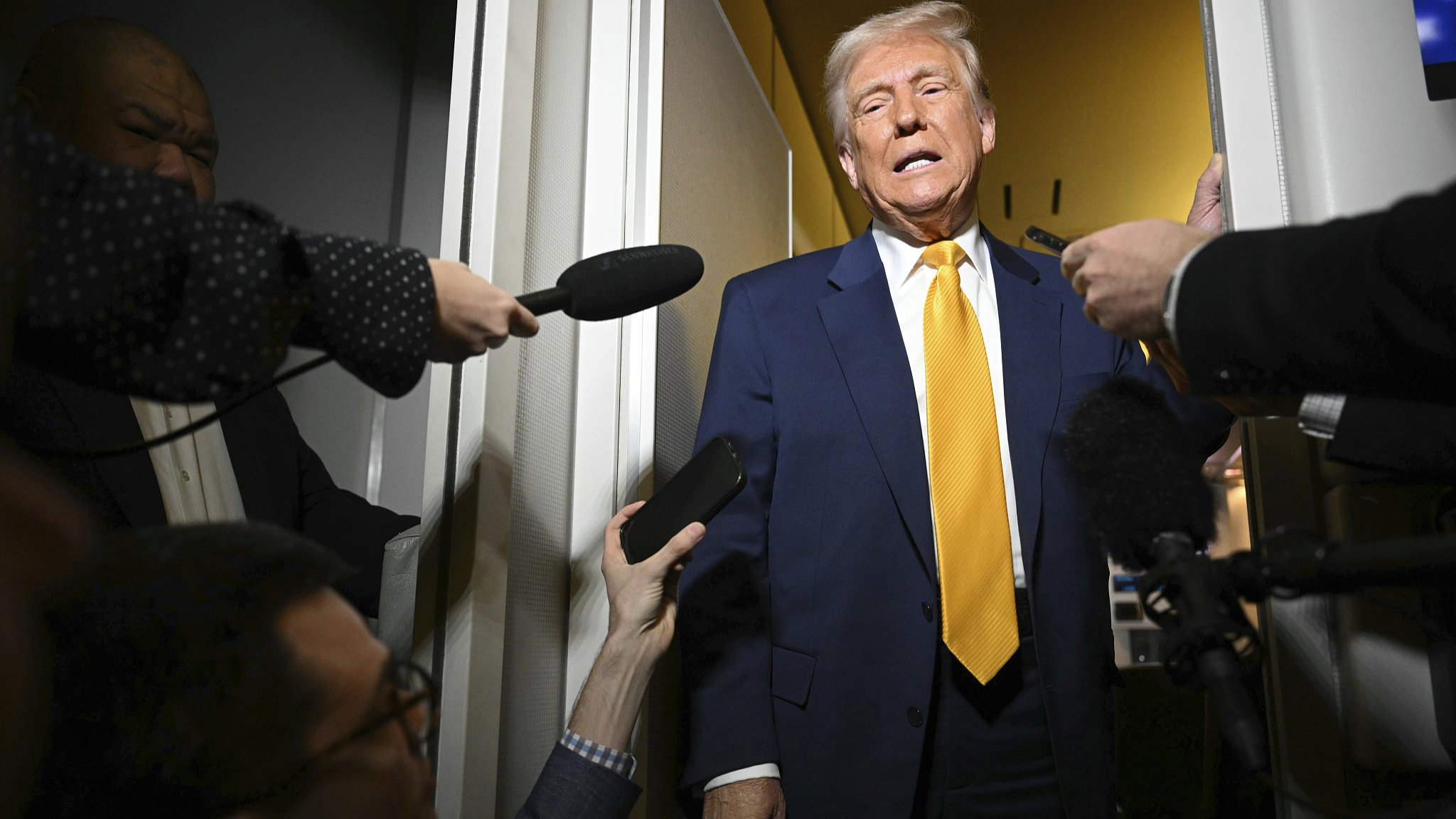 U.S. President Donald Trump speaks to the reporters on board Air Force One on the way to Miami, April 12, 2025. / VCG