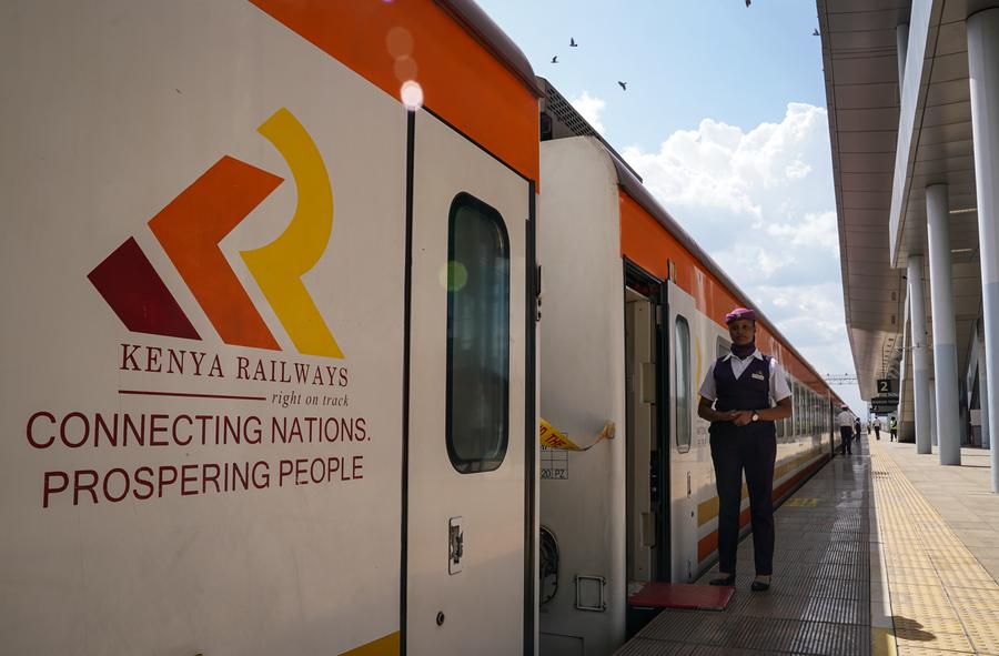 A stewardess stands next to the train to Mombasa at Nairobi Terminus Station of the China built Mombasa-Nairobi Standard Gauge Railway (SGR) in Nairobi, Kenya, Sept. 20, 2023. (Xinhua/Han Xu)
